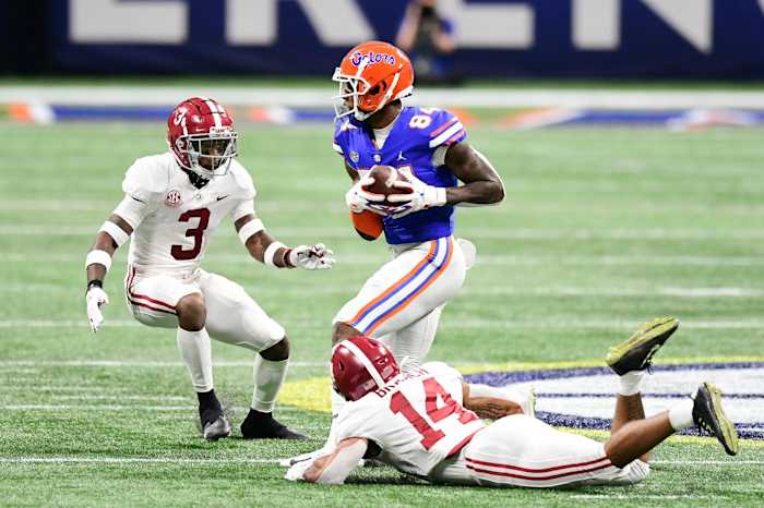 Dec 19, 2020; Atlanta, Georgia, USA; Florida Gators tight end Kyle Pitts (84) makes a catch against Alabama Crimson Tide defensive back Daniel Wright (3) and Alabama Crimson Tide defensive back Brian Branch (14) at Mercedes-Benz Stadium.